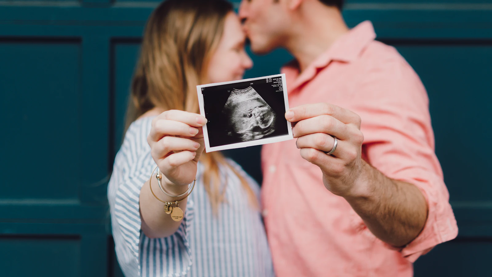 A couple holding an ultrasound photo