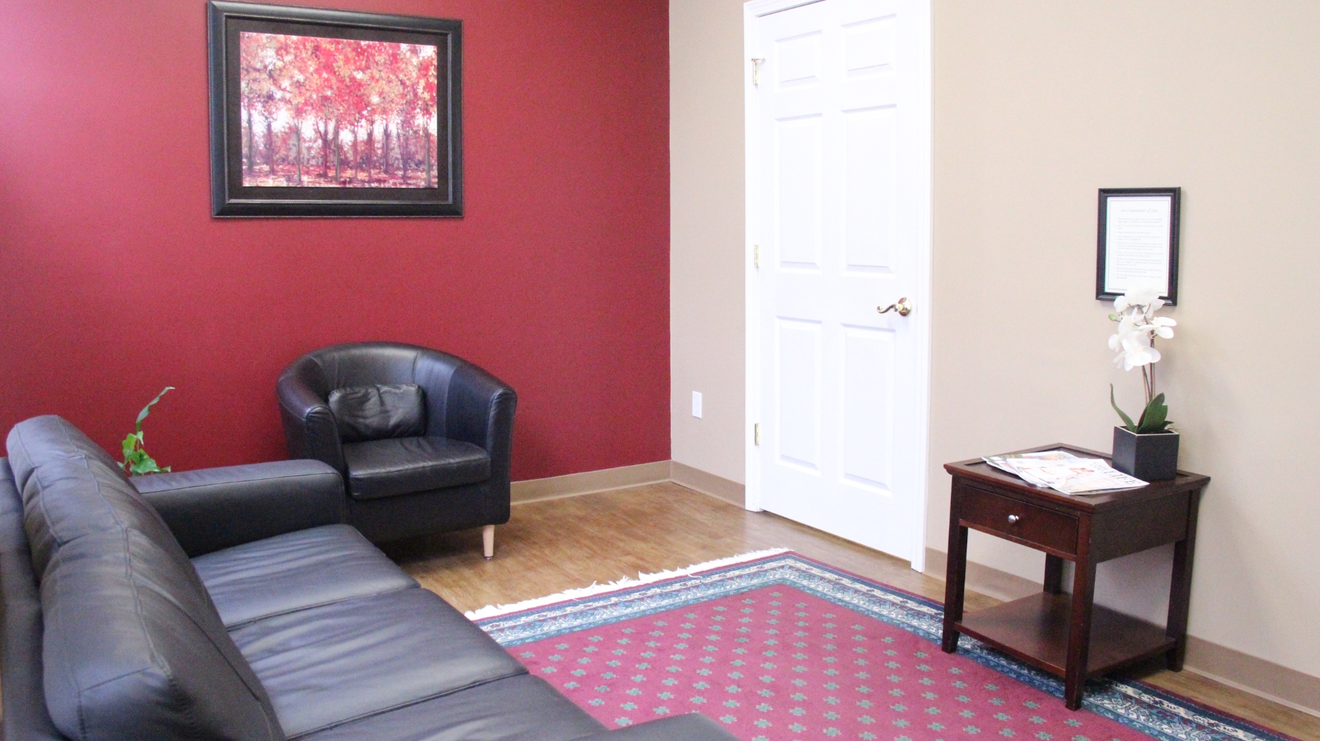 A welcoming front desk with a glass of water and intake clipboards.